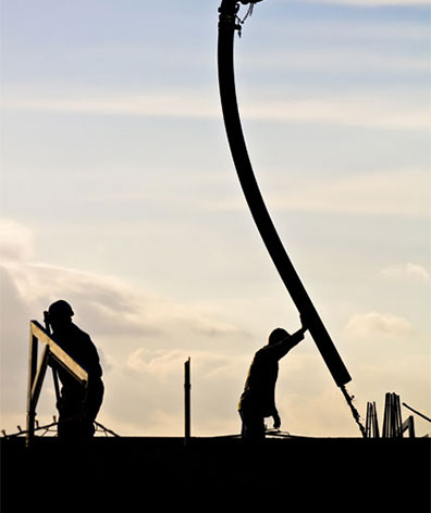 worker guiding concrete hose